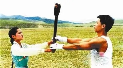 1990年8月7日，在西藏的念青唐古拉峰下，藏族少女达娃央宗将火炬交给体操王子李宁